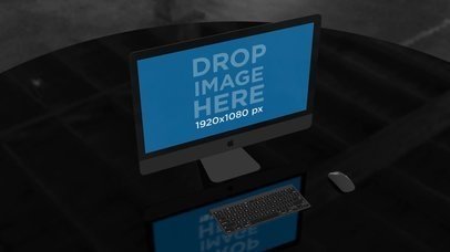 iMac Video Standing on a Table in a Dark Room a16242