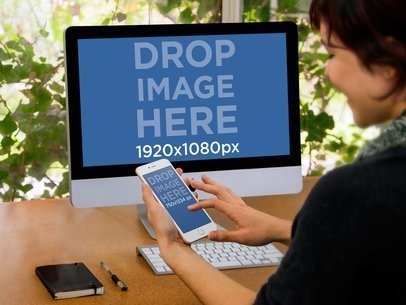 Girl Using iPhone 6 And iMac At Office